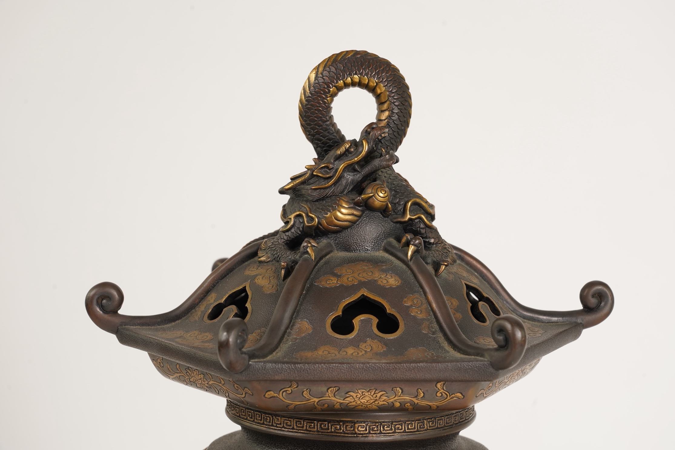 A large Japanese Miyao style parcel gilt bronze figure holding a koro aloft, 20th century
